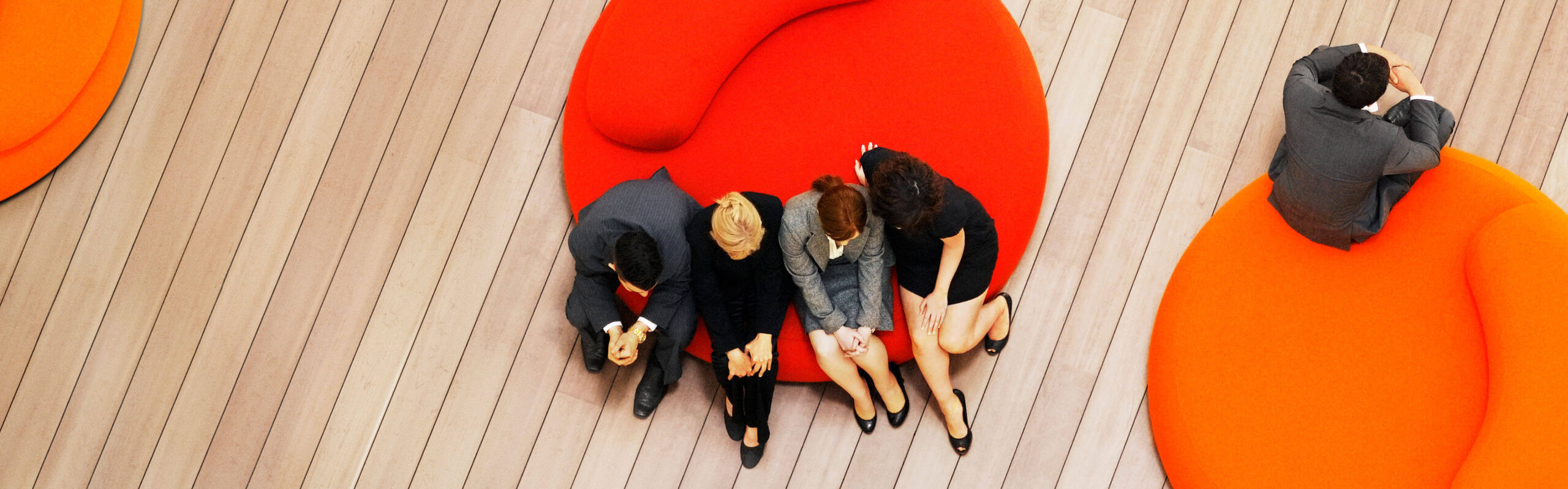 Office workers sitting on round couch