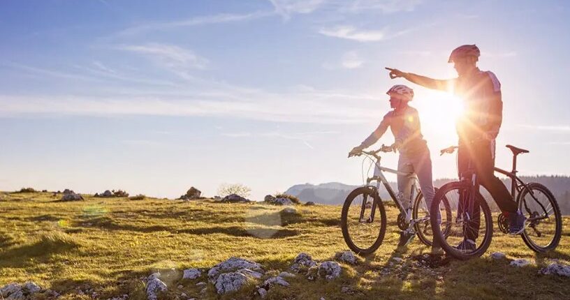 Adults riding bicycles stock image